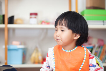 Oriental girl eating at home