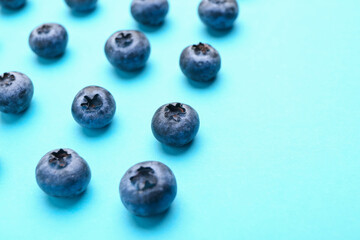 Tasty ripe blueberry on color background