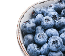 Tasty ripe blueberry in bowl on white background, closeup