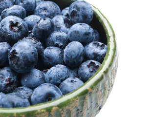 Tasty ripe blueberry in bowl on white background, closeup