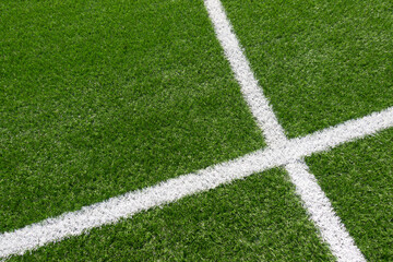 Green artificial grass turf soccer football field background with white line boundary. Top view