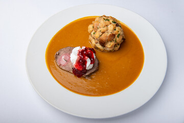 Sirloin with dumplings, whipped cream and cranberries
