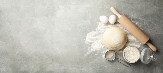 Fototapeten Brot Concept for baking with dough on gray background  © Atlas