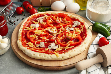 Concept for cooking pizza with ingredients on gray table