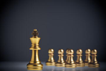 The golden king of chess stands out from the hordes of pawns behind it. Concept of leadership and success in business competition.