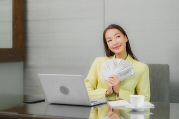 Fototapeta premium Portrait beautiful young asian woman use computer laptop with smart mobile phone on working table
