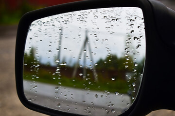 water droplets on the side mirror of a car