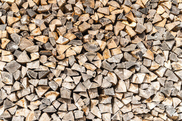 Stacked wood wooden logs firewood, textured background