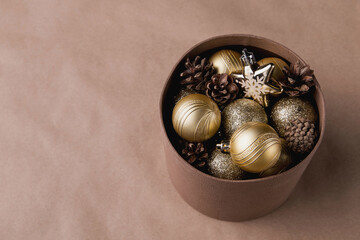 Obraz premium Christmas decor shiny balls, pine cones in a box, trendy modern photo in the style of minimalism