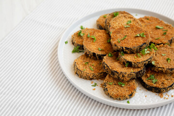 Homemade Garlic Parmesan Baked Eggplant on a plate, low angle view. Copy space.