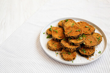 Homemade Garlic Parmesan Baked Eggplant on a plate, side view. Copy space.