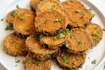 Homemade Garlic Parmesan Baked Eggplant on a plate, side view. Close-up.