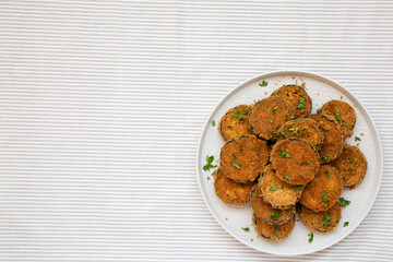 Homemade Garlic Parmesan Baked Eggplant on a plate, top view. Overhead, from above, flat lay. Copy space.