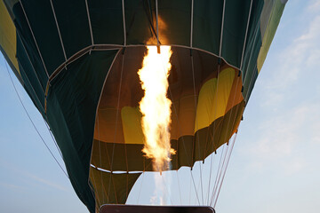 Blowing gas in colorful hot air balloon