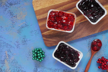 red berry and blueberry chess pie cake are on the wooden tray with wooden spoon on the wooden black...