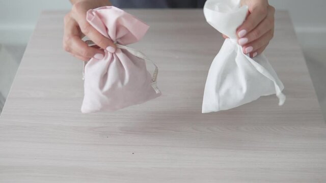 Two stylish sachet made with their own hands. Dry perfumes for underwear in bags dance on the table.