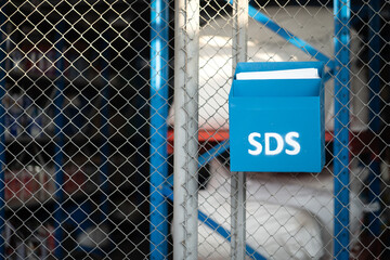 "Safety data sheet (SDS)" box which is use to placed chemical characteristic documents that locate in front of chemical storage room. Industrial object photo. 
