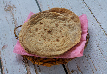 Heap of chapatis on a wicker tray