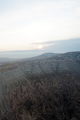 Natural landscape view from hot air balloon ride and tour in Kapadokya Goreme valley, semi-arid region known for its distinctive fairy chimneys, tall, cone-shaped rock formation- Cappadocia, Turkey