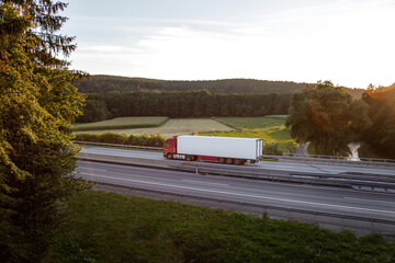 Transport with a refrigerated truck driving on a highway
