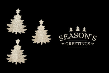Three cutout Christmas trees on black background with Seasons's greetings text