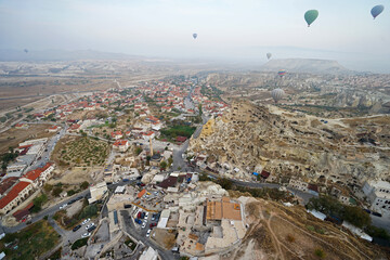 Colorful hot air balloon ride and tour in Goreme valley, semi-arid region in central Turkey known for its distinctive fairy chimneys, tall, cone-shaped rock formation- Cappadocia, Turkey