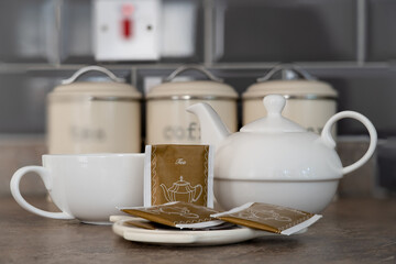 One person china tea set comprising of a tea pot and large cup integrated design used for the preparation and brewing of English breakfast tea and other beverages