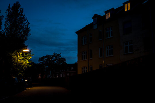 A Tall Yellow Building At Night With The Lights Off