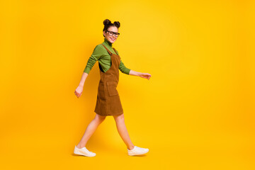 Fototapeta na wymiar Full length body size profile side view of her she attractive cheerful girl wearing velveteen going back to school visit lesson classes isolated bright vivid shine vibrant yellow color background