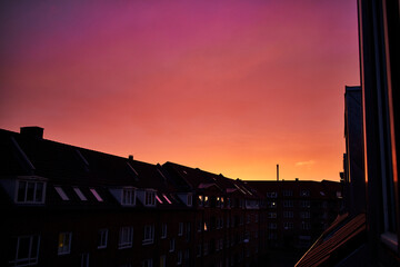 Magical purple and red sunset over rooftops