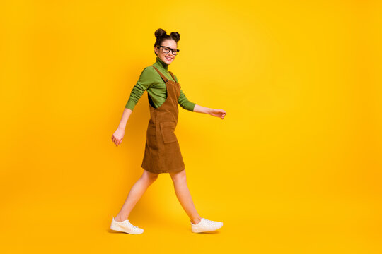 Full length body size profile side view of her she attractive cheerful girl wearing velveteen going back to school visit lesson classes isolated bright vivid shine vibrant yellow color background