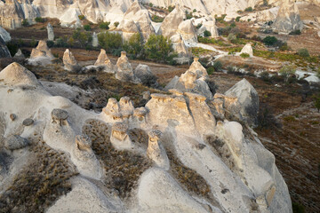 Natural landscape view from hot air balloon ride and tour in Kapadokya Goreme valley, semi-arid region known for its distinctive fairy chimneys, tall, cone-shaped rock formation- Cappadocia, Turkey