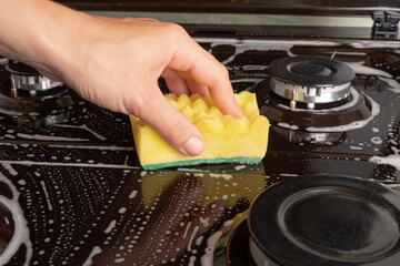 washing the gas stove in the kitchen
