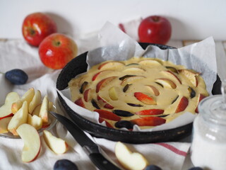 Round homemade Apple pie. Apple Charlotte close up with apples on a wooden background.Rustic style.