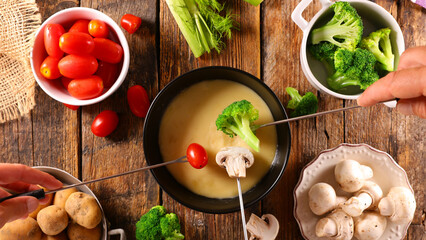 cheese fondue with fresh vegetable- broccoli, tomato, potato and mushroom