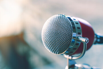 Fototapeta premium vintage microphone with color background in nightclub