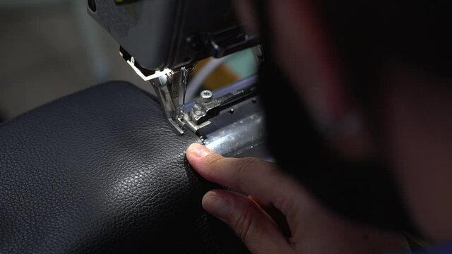 Close up of a woman sewing on the sewing machine