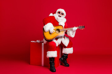 Full length photo of retired old man white beard hold guitar sit box play sing christmas carol song...
