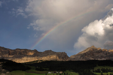summer rainbow on italian alps in Alta badia