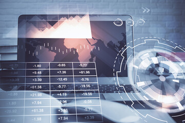 Stock market chart hologram drawn on personal computer background. Double exposure. Concept of investment.