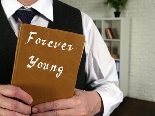 Financial concept about Forever Young with phrase on the page.