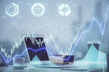 Forex Chart hologram on table with computer background. Multi exposure. Concept of financial markets.