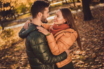 Photo of passionate affectionate couple girl hug soulmate boyfriend in fall forest september park wear jackets coats
