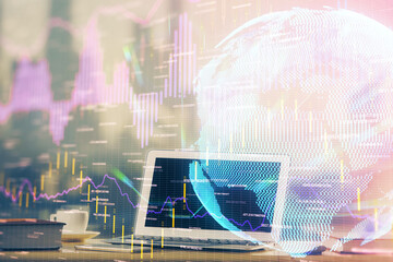 Financial graph colorful drawing and table with computer on background. Multi exposure. Concept of international markets.