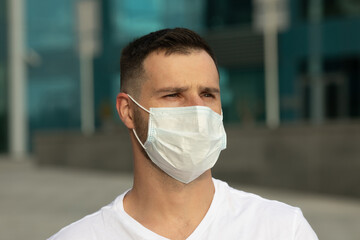 COVID-19 Pandemic Coronavirus Man in city street wearing face mask protective for spreading of Coronavirus Disease 2019.