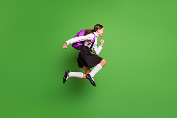 Photo portrait of brunette girl with pigtails running to school jumping up with pink backpack...