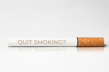 Quit smoking concept: close up of a cigarette with the message quit smoking printed on it