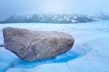 Top of Mendenhall glacier and huge boulders with melted ice under them in Juneau Ice field, Alaska