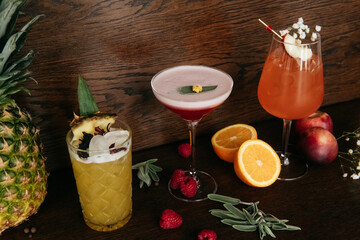 Fruit cocktails with pineapple, orange, nectarine and raspberry on the table in restaurant
