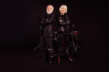 Obraz premium Photo of two pensioners people family cool aged lady man rock band group all life together concert show drum instruments wear trendy rocker leather outfit isolated black color background